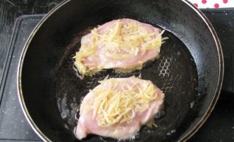 Сковородку с растительным маслом разогреть и аккуратно выложить куриные отбивные в картофельной стружке и кляре.